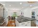 Bright kitchen with white cabinets, stainless steel appliances, and dining area with hardwood floors at 3008 S Church Ave, Tampa, FL 33629