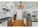 Modern kitchen with stainless steel appliances, stone countertops, and white cabinets at 3008 S Church Ave, Tampa, FL 33629