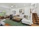 Inviting living room with hardwood floors, stylish décor, and staircase access to upper level at 3008 S Church Ave, Tampa, FL 33629