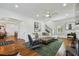 Spacious living room with hardwood floors, fireplace, modern furnishings, and natural light at 3008 S Church Ave, Tampa, FL 33629