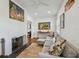 Comfortable living room with fireplace, hardwood floors, and natural light from shuttered windows at 3008 S Church Ave, Tampa, FL 33629