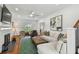 Bright living room with hardwood floors, fireplace, and view into foyer and other living spaces at 3008 S Church Ave, Tampa, FL 33629