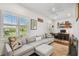 Comfortable living area with a gray sectional, shutters, and a dedicated workspace at 3008 S Church Ave, Tampa, FL 33629