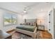 Serene primary bedroom with a tufted headboard, ceiling fan, and bright natural light at 3008 S Church Ave, Tampa, FL 33629
