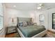 Bedroom with hardwood floors, ceiling fan, and view of the bathroom at 3008 S Church Ave, Tampa, FL 33629