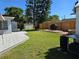 A large backyard with a grill, a wooden fence, and a storage shed at 315 Shore E Dr, Oldsmar, FL 34677