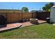 An outdoor backyard features a stone fire pit and a wood fence, creating a cozy and private space at 315 Shore E Dr, Oldsmar, FL 34677