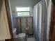 Bathroom with a toilet, shower with curtain, and window at 315 Shore E Dr, Oldsmar, FL 34677