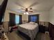 Bedroom featuring a ceiling fan and comfortable queen-sized bed at 315 Shore E Dr, Oldsmar, FL 34677