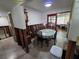 Dining area awaiting remodel, featuring a dining table and a view to another room with sliding doors at 315 Shore E Dr, Oldsmar, FL 34677