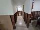Hallway awaiting remodel, featuring exposed studs and view of a room with a mirror at the end at 315 Shore E Dr, Oldsmar, FL 34677