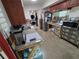Kitchen awaiting remodel with abundant storage, stainless steel refrigerator, and adjacent laundry at 315 Shore E Dr, Oldsmar, FL 34677