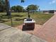 A memorial features boots, a rifle, and a helmet on a pedestal, honoring veterans at 315 Shore E Dr, Oldsmar, FL 34677