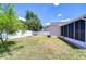 Expansive backyard featuring lush green grass, a vinyl privacy fence, and screened in lanai at 316 Crystal Goblet Ct, Valrico, FL 33594