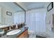 Bathroom featuring granite countertop, a framed mirror and shower with a curtain at 316 Crystal Goblet Ct, Valrico, FL 33594