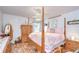 Charming bedroom with hardwood floors, a ceiling fan, and a four-poster bed at 316 Crystal Goblet Ct, Valrico, FL 33594