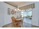 Dining room with light wood table and chairs, chandelier lighting, and sliding glass doors to the sunroom at 316 Crystal Goblet Ct, Valrico, FL 33594