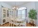 Formal dining room with hardwood floors, dining table, china cabinet and a large window at 316 Crystal Goblet Ct, Valrico, FL 33594