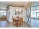 Bright dining room featuring a wood table, chandelier lighting, tiled floors, and sliding glass doors to the sunroom at 316 Crystal Goblet Ct, Valrico, FL 33594
