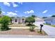 Charming single-story home with manicured lawn, decorative landscaping and a two-car garage at 316 Crystal Goblet Ct, Valrico, FL 33594