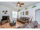 Cozy living room with hardwood floors, ceiling fan, and comfortable leather furniture set at 316 Crystal Goblet Ct, Valrico, FL 33594