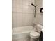 A clean bathroom with tiled shower, tub, and toilet, designed for comfort and functionality at 3206 W Azeele St # 108, Tampa, FL 33609