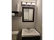 Bathroom featuring a vanity with mirror, toilet, and convenient shelving for storage at 3206 W Azeele St # 108, Tampa, FL 33609