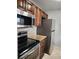 Kitchen features stainless steel appliances, wooden cabinets and tiled backsplash at 3206 W Azeele St # 108, Tampa, FL 33609