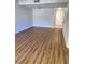 Open-concept living area boasts stylish wood floors and natural light at 3206 W Azeele St # 108, Tampa, FL 33609