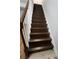 Elegant staircase with wood treads and white risers leads to upper level at 3206 W Azeele St # 108, Tampa, FL 33609