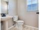 Bathroom with a pedestal sink, toilet, tile flooring, and window at 3434 E Keysville Rd, Lithia, FL 33547
