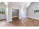 Large bedroom featuring hardwood floors, neutral colors, and multiple windows at 3434 E Keysville Rd, Lithia, FL 33547