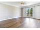 Spacious bedroom featuring wood flooring and sliding barn doors leading to a private balcony at 3434 E Keysville Rd, Lithia, FL 33547