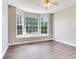 Bright bedroom featuring beautiful hardwood floors and a large bay window at 3434 E Keysville Rd, Lithia, FL 33547