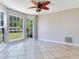 Bright bonus room featuring tiled flooring and large windows with picturesque backyard views at 3434 E Keysville Rd, Lithia, FL 33547