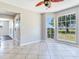 Bright dining area with tile floor, three windows, and a ceiling fan overlooking the front yard at 3434 E Keysville Rd, Lithia, FL 33547