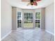 Bright dining area with bay windows offering lovely views and a unique leaf-themed ceiling fan at 3434 E Keysville Rd, Lithia, FL 33547