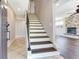 Inviting entryway with beautiful tile flooring and a staircase leading to the upper level at 3434 E Keysville Rd, Lithia, FL 33547