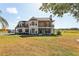 Elegant two-story home featuring a front-facing balcony and lush landscaping, enhancing its curb appeal at 3434 E Keysville Rd, Lithia, FL 33547