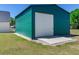 Side view of large steel green garage with roll up doors at 3434 E Keysville Rd, Lithia, FL 33547
