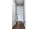 Hallway with wood floors, leading into a room with access to two large storage closets at 3434 E Keysville Rd, Lithia, FL 33547