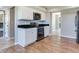 Kitchen featuring wooden floors, stainless steel appliances, and sleek black countertops at 3434 E Keysville Rd, Lithia, FL 33547