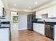 Bright kitchen with stainless steel appliances, granite counters, and wood flooring at 3434 E Keysville Rd, Lithia, FL 33547