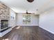 Open-concept living area with hardwood flooring, fireplace and natural light throughout at 3434 E Keysville Rd, Lithia, FL 33547