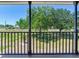 Inviting porch with wood railings and a picturesque view of the front yard at 3434 E Keysville Rd, Lithia, FL 33547