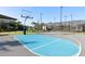 Well-maintained basketball court with vibrant blue and gray surfaces, perfect for recreation at 3488 Great Banyan Way, Wesley Chapel, FL 33543