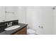 Compact bathroom featuring granite countertops, modern fixtures, and a clean white toilet at 3488 Great Banyan Way, Wesley Chapel, FL 33543