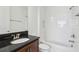 A well-appointed bathroom with granite countertops and a shower-tub combination at 3488 Great Banyan Way, Wesley Chapel, FL 33543