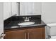 Bathroom featuring a granite countertop, wood cabinets, and modern fixtures at 3488 Great Banyan Way, Wesley Chapel, FL 33543
