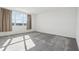 A bedroom featuring carpeted floors, neutral walls, and a large window at 3488 Great Banyan Way, Wesley Chapel, FL 33543